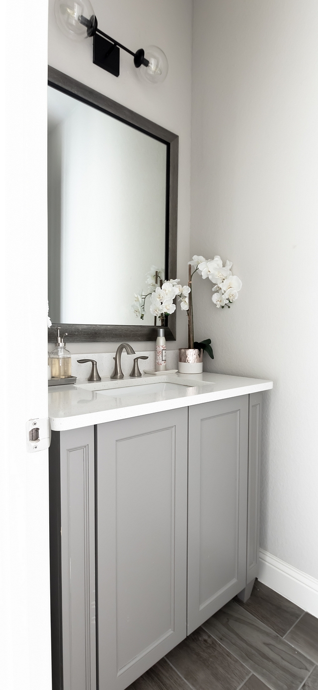 The powder room features a grey vanity, painted in Chandler Pewter #greyvanity #powderroom