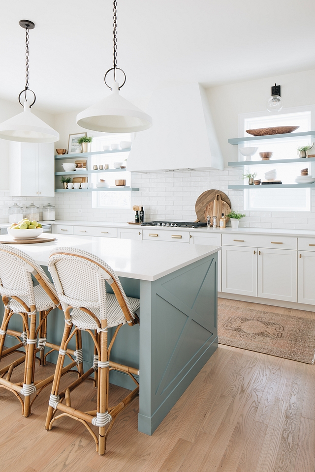 Kitchen Blue Gray Kitchen island paint color, floating shelves falnking hood, 2x10 white subway tile, light oak hardwood flooring, white walls, vintage runner, Caesarstone Organic White countertop #kitchen #Kitchenisland #kitchenpaintcolor #floatingshelves #hood #whitesubwaytile #oakhardwoodflooring #whitewalls #vintagerunner #CaesarstoneOrganicWhite #countertop #kitchenrunner