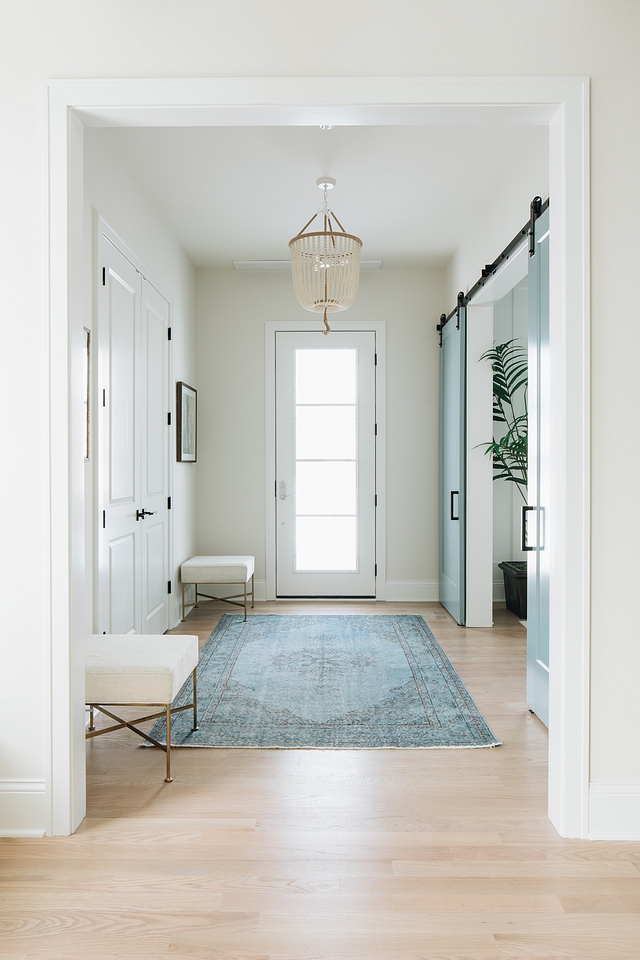 Benjamin Moore Classic Gray foyer with white trim and aqua blue barn doors leading to home office Benjamin Moore Classic Gray Benjamin Moore Classic Gray Benjamin Moore Classic Gray Benjamin Moore Classic Gray #BenjaminMooreClassicGray #foyer #bluebarndoor #aquabarndoor #barndoor