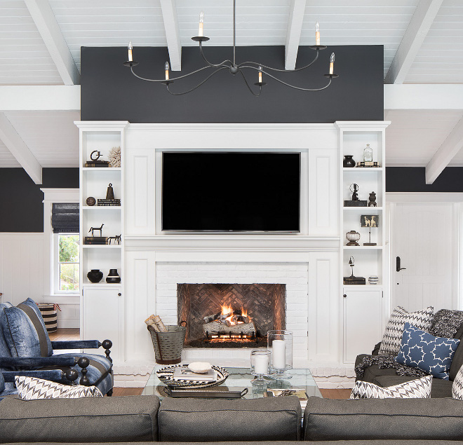 The fireplace at the center of the great room was originally a cream marble. To freshen it up and add a sense of history we added an Italian black Chicago brick in a herringbone pattern, and white painted Chicago brick for the surround and hearth #fireplace #brick #builtins