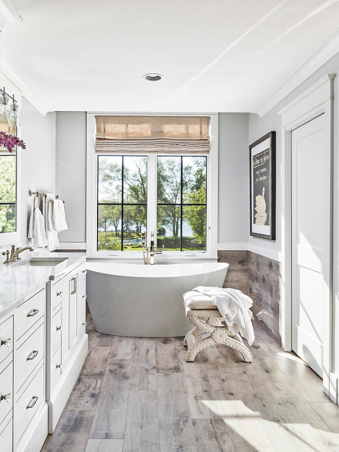 Master bathroom flooring We used a ceramic tile that resembles wood planks on the floor and brought it 3 feet as a wainscoting up the wall to give a more intimate feel #Masterbathroom #flooring #tile #woodtile #woodtiling #bathroomwainscoting