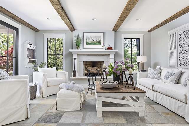 Farmhouse family room We chose lighter shades of Celadon slate for the flooring. The distressed beams reflect driftwood. The limestone fireplace adds the needed warmth for those chilly evenings Farmhouse family room #Farmhousefamilyroom #farmhouse