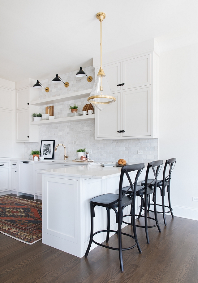 Townhouse Kitchen Design Because this townhouse has another unit attached, the kitchen of this home does not have a window in the prep area. We used floating shelves over the kitchen sink to create an open and airy feeling where one usually has a window. If we would have carried the cabinets all around the boxy shaped room it would have felt very closed up and boring. The shelves add so much interest and depth to the kitchen #townhousekitchen #townhouse #kitchen