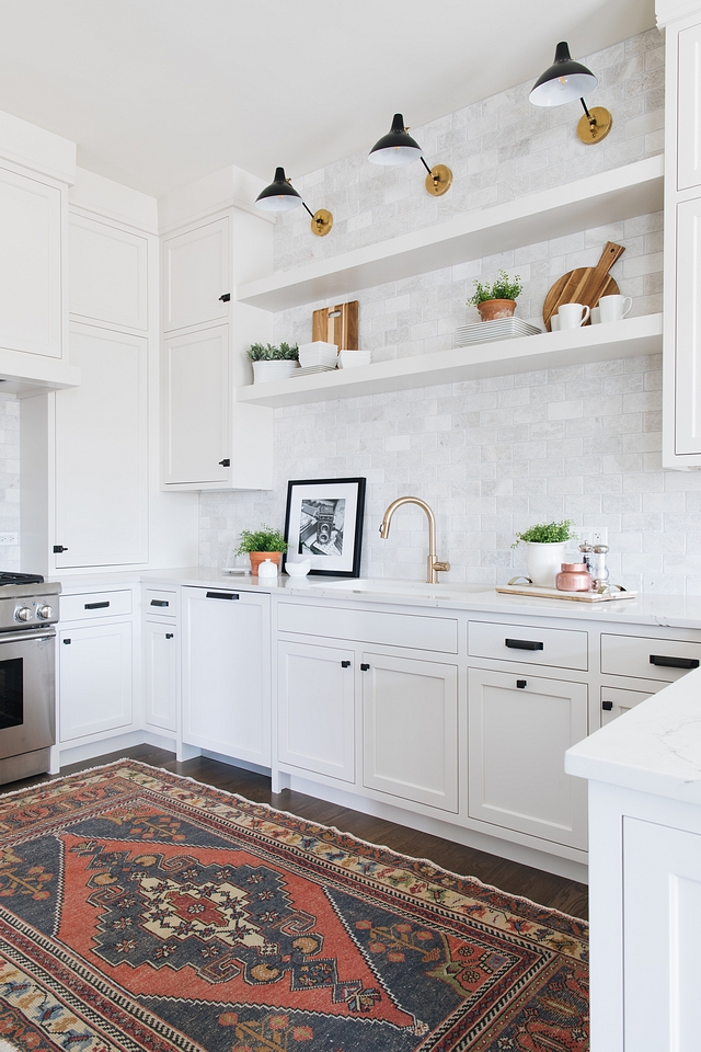 Kitchen Shelves Some people will actually use kitchen floating shelves to hold their utility items and grab at them like a chef at a restaurant. I however, like to save that stuff for closed cabinets and use the floating shelves as an area to style like a bookcase. Using frames leaning and stacked up against each other creates a really nice look along side your more traditional kitchen items #kitchenshelves