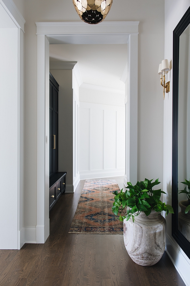 Mudroom Hallway Mudroom The mudroom of this house is actually a hallway that connects the bedrooms, the garage, and the laundry room. There is not a closed off area where mess can accumulate. We needed to make sure the mudroom had more than just hooks and a bench. That would get very messy to walk past every day. We had custom built-ins made that hide all the mess The board and batten on the walls gives an architectural feel but also helps to protect the walls in a high traffic area Mudroom Hallway Mudroom #Mudroom #HallwayMudroom