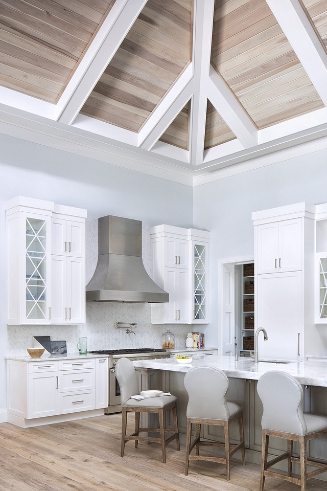 Benjamin Moore Silver Cloud Crisp white kitchen cabinets, along with white marble countertop and chevron backsplash, complement the blue gray walls, painted in Benjamin Moore Silver Cloud #BenjaminMooreSilverCloud