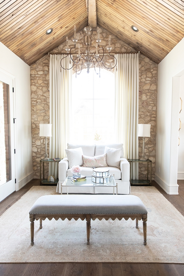 Interior natural stone accent wall Stone is Castlerock stone in a mix of cream and white with white mortar Bedroom sitting room with cathedral vault ceiling and natural stone accent wall Rustic French Interior Design #bedroom #sittingroom #RusticFrench #InteriorDesign #naturalstoneaccentwall