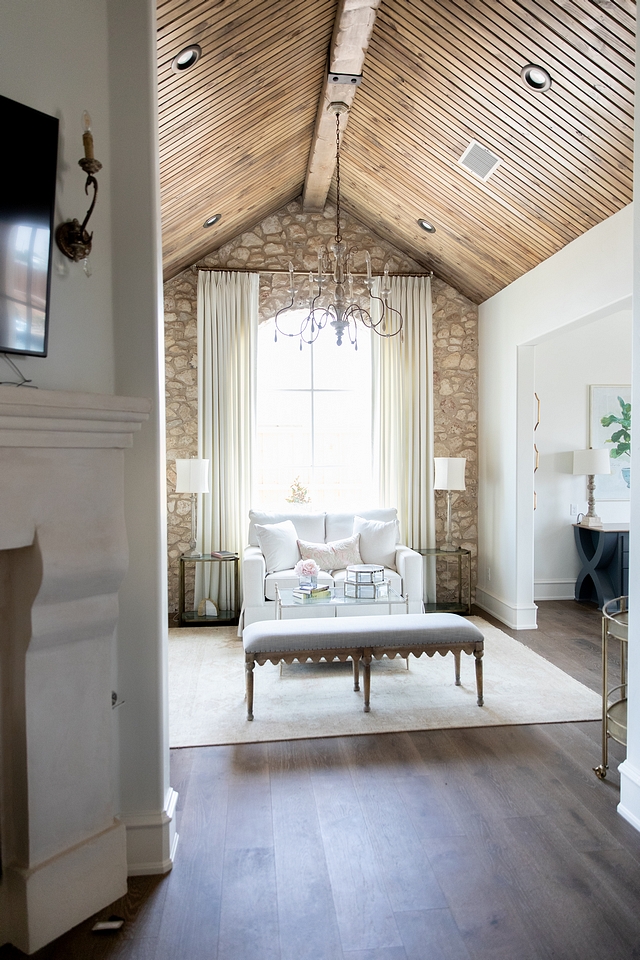 Bedroom sitting room with cathedral ceiling clad in tongue and groove paneling and stone accent wall French master bedroom sitting room with cathedral ceiling clad in tongue and groove paneling #Bedroom #sittingroom #Frenchbedroom #Frenchsittingroom #cathedralceiling #tongueandgroove ##tongueandgrooveceiling