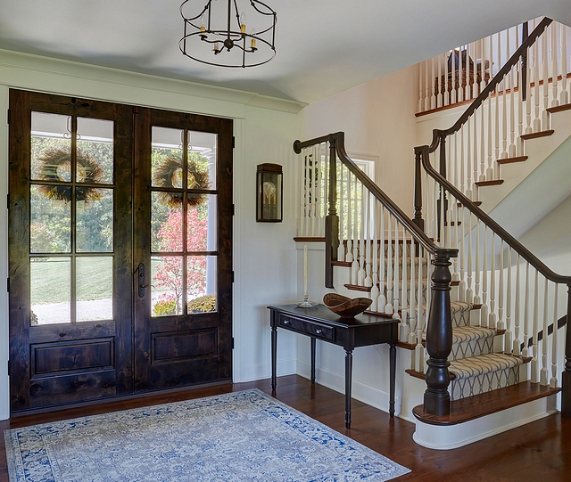 Wood front door The front doors open to a traditional foyer The front door is a pair of Master Crafted Door with 3-point locking mechanism, divided lites, and raised panel at lower part of the doors in knotty alder #wooddoor #frontdoor #traditionalfoyer #foyer #knottyalder #door