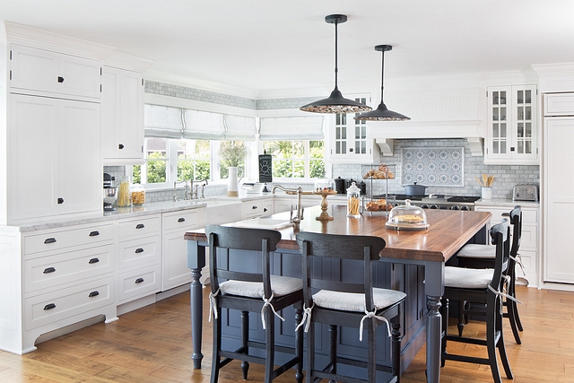 White kitchen with blue steel island In the kitchen, we painted the existing white island a steel blue Cabinets are in Benjamin Moore White Dove #whitekitchen #BenjaminMooreWhiteDove