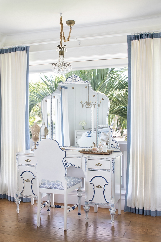 The make-up vanity and chair are antiques, refinished in Benjamin Moore White Dove and hand-painted blue accents
