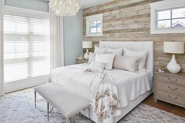 The master bedroom features a barn wood shiplap accent wall #shiplap #barnwood #barnwoodshiplap