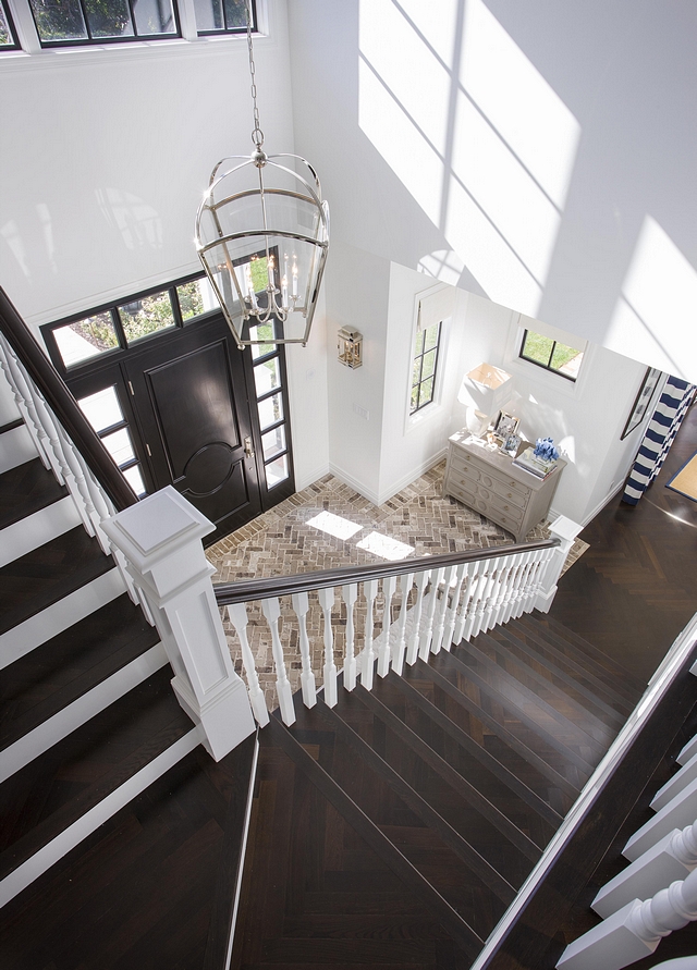 Entryway Brick Flooring and Herringbone Hardwood Flooring The entryway features brick flooring and a stunning staircase with Ebony herringbone hardwood flooring Entryway Brick Flooring and Herringbone Hardwood Flooring #Entryway #BrickFlooring #HerringboneHardwoodFlooring #HerringboneFlooring #HardwoodFlooring #Hardwood #Flooring