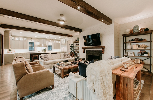 Living room featuring fireplace wall with shiplap and chevron wall paneling #shiplap #wallpaneling #cheronshiplap #chevronpaneling #livingoom #fireplace