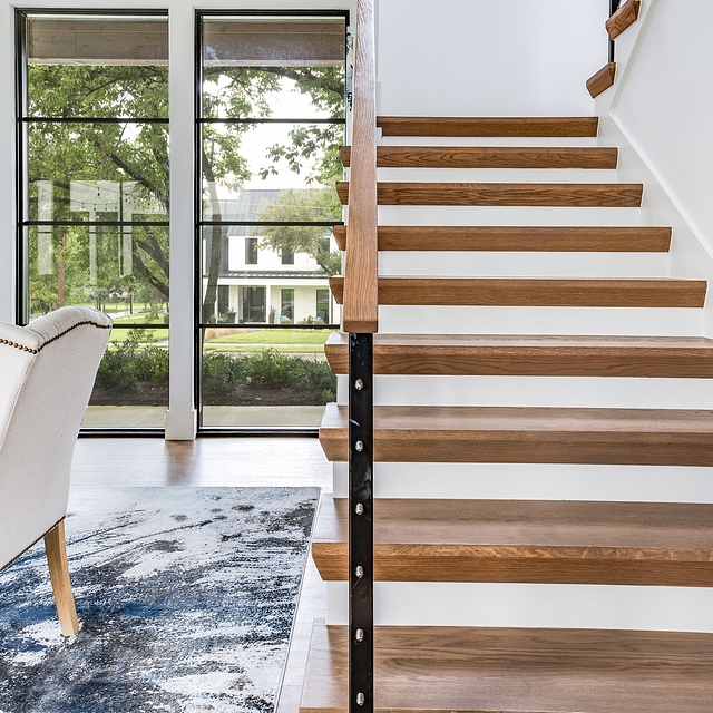 Modern farmhouse staircase photos Modern farmhouse staircase featuring wood treads and metal and cable railing #Modernfarmhousestaircase #woodtreadstaircase #staircase #metalandcablerailing #cablerailing #cablerailingstaircase