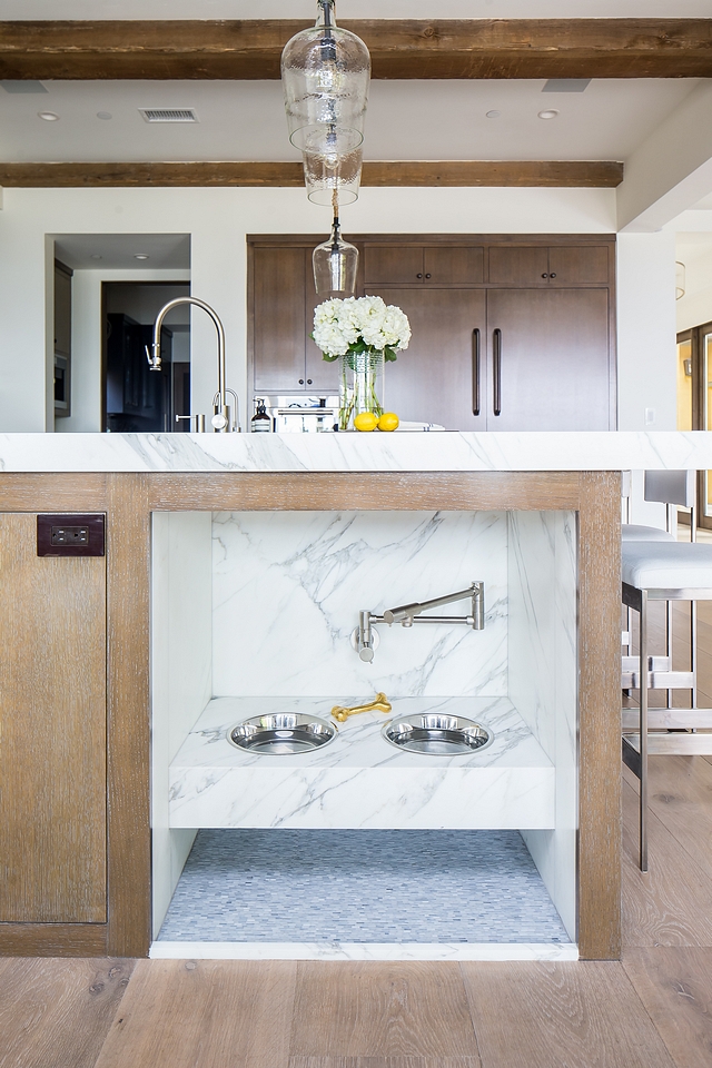  Kitchen Island with Pet Feeding Station This kitchen island features a custom dog feeding station that comes even with a swing arm faucet (pot filler) to easily refill the water bowls #KitchenIsland #PetFeedingStation #dogfeedingstation #potfiller