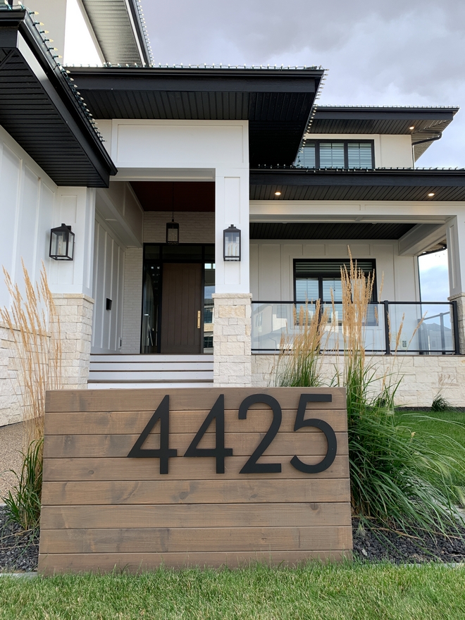 The exterior of this gorgeous home is complemented by a Mid-century inspired address sign with horizontal wood planks and extra large house numbers