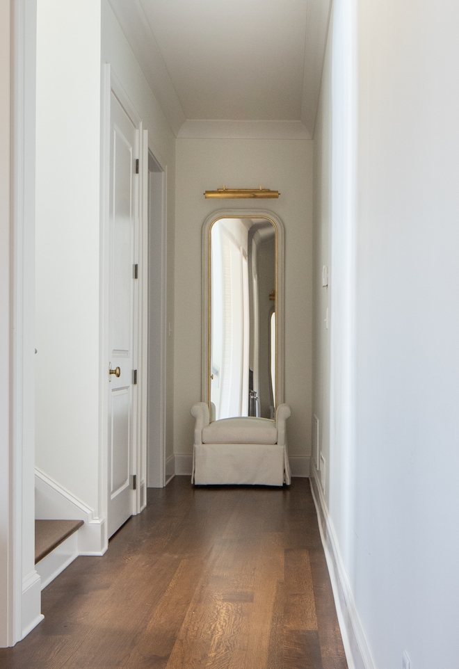 The ends of the hallways were originally supposed to be closets. Once feeling the space and walking in multiple times we came to the conclusion that these two areas would be the perfect place to mirror one another to help balance the long hallway. We married the two ends together by adding the same mirror, bench and light fixture to both spaces. We felt by doing so it helped balance the long space and allow guests to feel a sense of unity from one end to the other