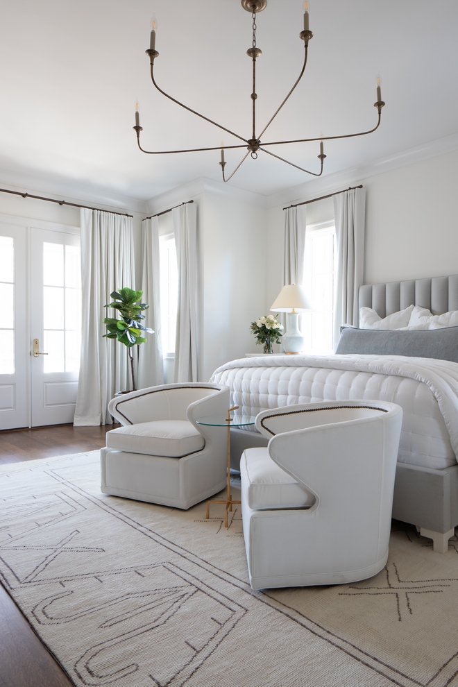 The master bedroom might be one of our favorites we have ever done We married our aesthetics of modern and traditional and created a serene escape for the homeowners We started with the amazing rug and brought the blue accent color into the space in the custom upholstered bed frame and the gorgeous lamps from Visual Comfort