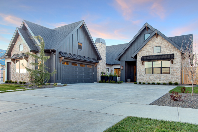 Modern Farmhouse Exterior This house was all about mixing materials even on the exterior We used stucco board and batten and stone topped it off with gas lanterns and great landscaping Modern Farmhouse Exterior