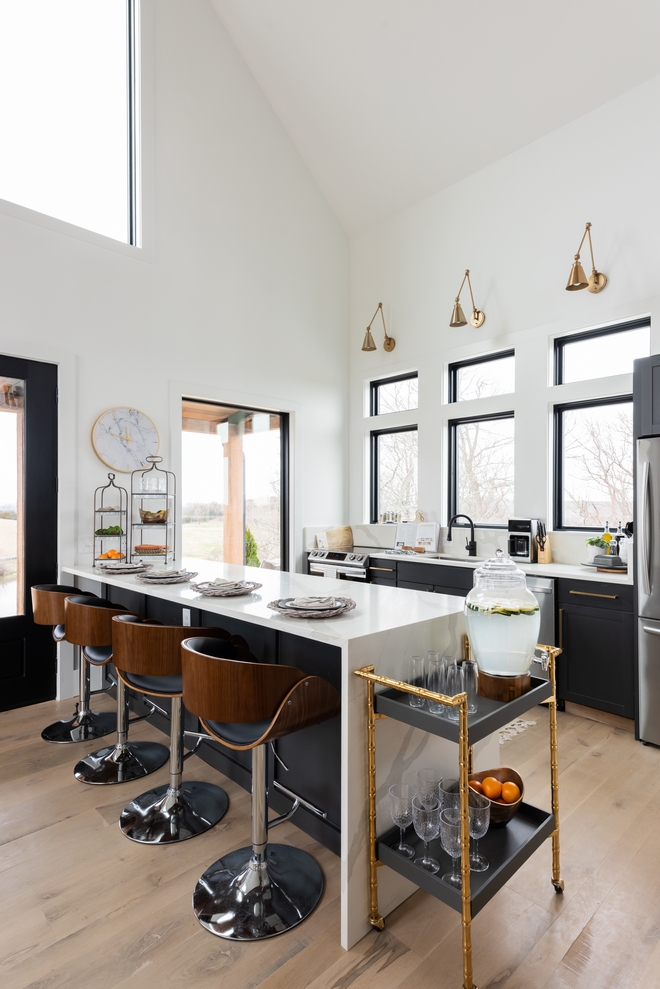 Kitchen Windows allow plenty of natural light into this practical and stylish Kitchen while a large peninsula with a waterfall countertop offers plenty of storage and it is the perfect place to eat your casual meals