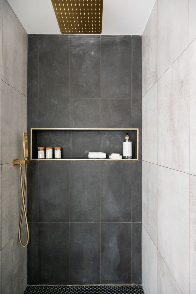 Concrete-looking tiles keep this shower feeling simple organic and low-maintenance