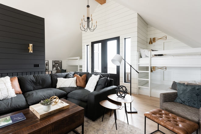 French doors to a private balcony are accentuated with white shilplap and flanked by custom Bunk Beds