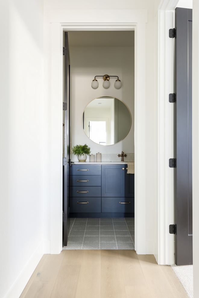 The powder bath is actually a full bathroom but I didn't want to lose the whimsy that usually tags along with a powder so I went with a patterned floor tile that looks like vintage wallpaper and an aged look gray shower wall tile to support the look