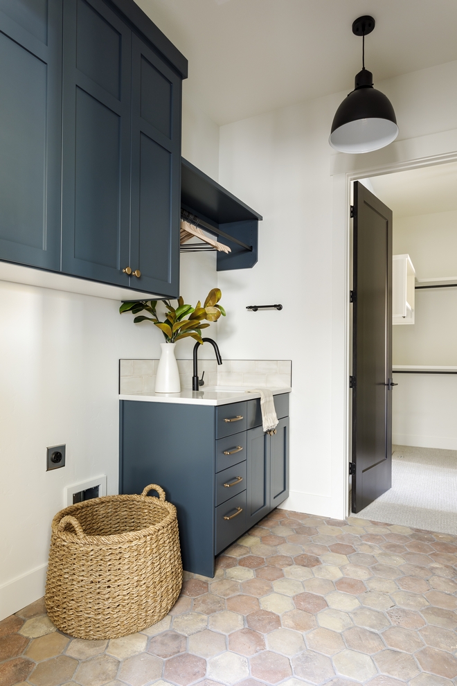 Farmhouse Laundry Room French Farmhouse Laundry Room with reclaimed hexagon tile and blue green cabinets with brass hardware