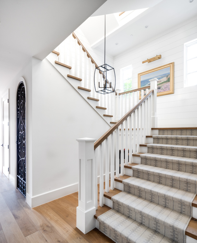 Coastal-Home-Staircase-White-wood-rails-painted-in-Dunn-Edwards-Antique-Paper-Treads-and-railings-are-custom-stained-to-match-hardwood-floors