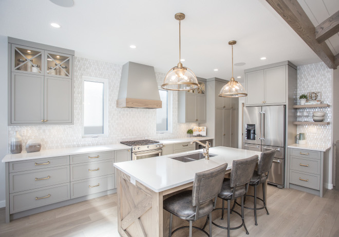 The kitchen features windows on either side of the range bringing natural light into the workspace The kitchen features windows on either side of the range bringing natural light into the workspace #kitchen #kitchenwindows #range #naturallight