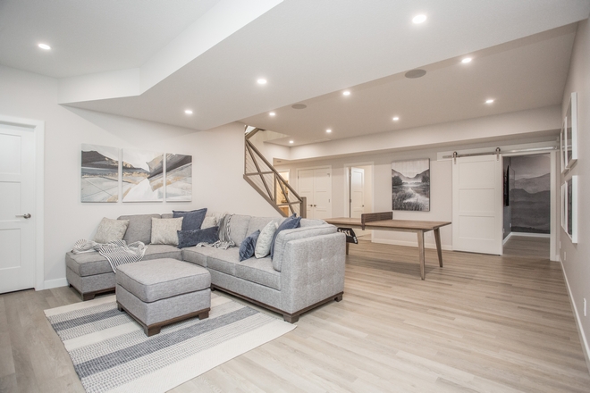 Basement Layout The basement features a large family room and wet bar as well as a theater room enclosed by a sliding barn door #Basement #BasementLayout #familyroom #wetbar #theaterroom #slidingbarndoor #barndoor