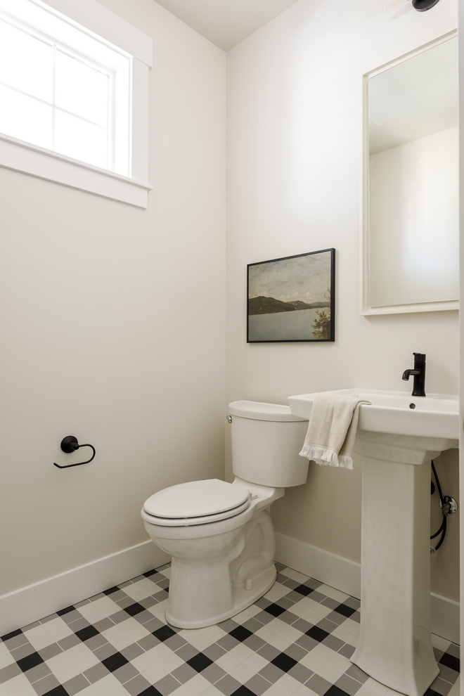 In the Powder Room neutral walls in Sherwin Williams Egret White are complemented by an inspiring plaid-patterned floor tile