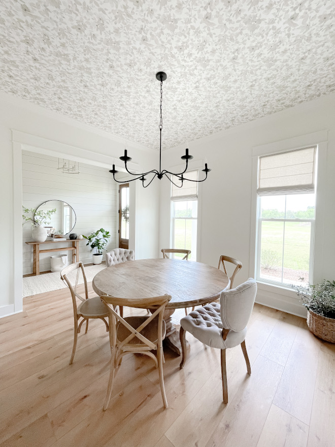 A dining room located just off the foyer features a neutral trendy floral ceiling wallpaper Ceiling Wallpaper Ceiling Wallpaper Ideas #diningroom #trendy #wallpaper #ceilingwallpaper