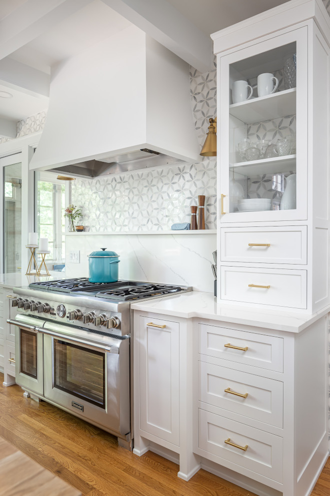 Marble and Quartz Slab Backsplash Kitchen Marble and Quartz Slab Backsplash Instead of bringing this marble tile all the way down to the stovetop, we added a small slab of the Calacatta Ultra Quartz so our homeowners would not have to worry about maintenance #Marble #Quartz #SlabBacksplash #Kitchen #Backsplash