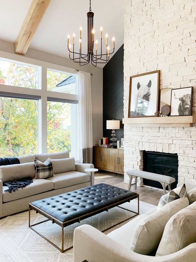 Custom angled Shiplap paneling flanks the stone fireplace Shiplap paint color is Sherwin Williams SW 7069 Iron Ore #angledShiplap #shiplap #paneling #stonefireplace #Shiplappaintcolor #SherwinWilliamsIronOre #SherwinWilliams