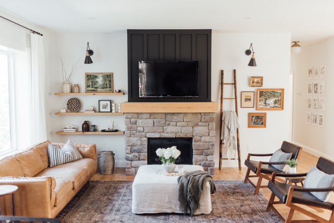 Living room with small kids Having a mix of old and new pieces and playing with different types of materials like wood side tables the leather sofa and linen covered ottoman look really lovely but also are really functional for a family with young kids #Livingroom #smallkidsinteriors #woodsidetable #leathersofa #linencoveredottoman #familywithyoungkids