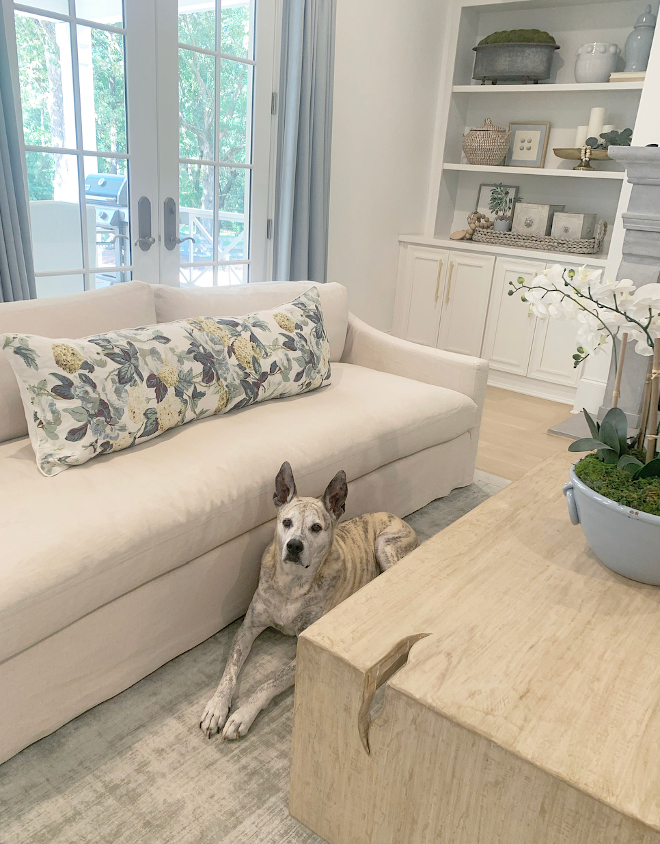 Neutral coastal blue and white living family room home decor open floor plan blue pleated curtains Long floral pillow white linen sofa Slope Arm Deep Seat Slipcovered Sofa Neutral coastal blue and white living family room home decor open floor plan blue pleated curtains Long floral pillow white linen sofa Slope Arm Deep Seat Slipcovered Sofa #Neutrallivingroom #coastallivingroom #blueandwhite #livingroom #familyroom #homedecor #openfloorplan #bluecurtains #pleatedcurtains #floralpillow #whitelinensofa #SlopeArmsofa #DeepSeatsofa #SlipcoveredSofa