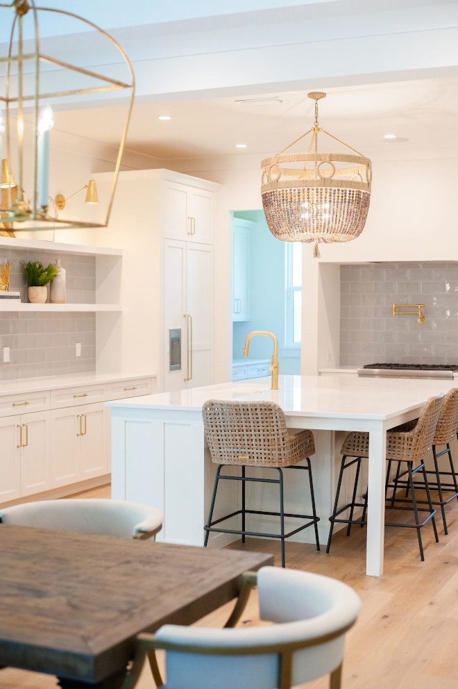 White coastal kitchen featuring white cabinets white quartz countertop and oversized grey subway tiles Kitchen White coastal kitchen featuring white cabinets white quartz countertop and oversized grey subway tiles #Whitecoastalkitchen #coastalkitchen #whitecabinets #whitequartz #quartzcountertop #oversizedtile #greysubwaytiles #greysubwaytile #kitchen