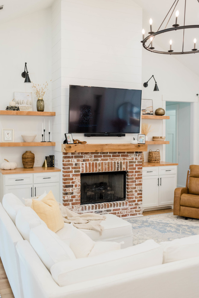 Brick Fireplace I love all of the wood accents in this room they help to bring so much warmth to this large open space #brickfireplace #fireplace #wood #livingroom