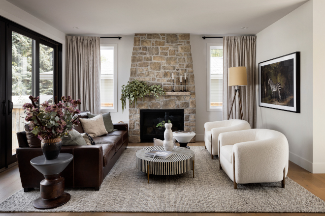 Living room Feeling connected to the Kitchen this Living Room is warm and full of interesting furniture pieces The showstopper is certainly that timeless stone fireplace Feeling connected to the Kitchen this Living Room is warm and full of interesting furniture pieces The showstopper is certainly that timeless stone fireplace #Livingroom #warminteriors #interesting #furniturepieces #showstopper #timeless #stonefireplace #fireplace