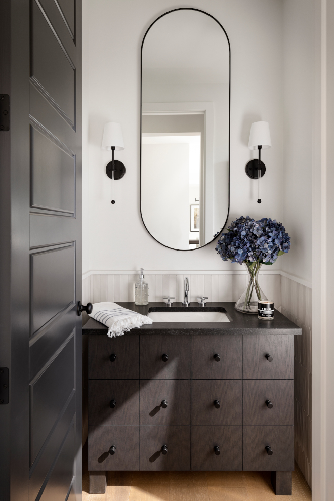 Powder Room features a White Oak vanity with a dark custom stain Picket tile wainscotting and black Pill shaped mirror Powder Room features a White Oak vanity with a dark custom stain Picket tile wainscotting and black Pill shaped mirror Powder Room features a White Oak vanity with a dark custom stain Picket tile wainscotting and black Pill shaped mirror Powder Room features a White Oak vanity with a dark custom stain Picket tile wainscotting and black Pill shaped mirror #PowderRoom #WhiteOakvanity #darkstain #customstain #Pickettile #tilewainscotting #blackPillshapedmirror #Pillshapedmirror