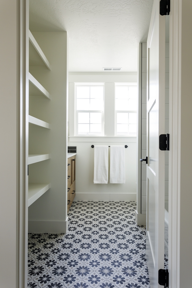 A flower patterned tile along with custom stacked shelves add plenty of character to this Bathroom #flowertile #patternedtile #sackedshelves #Bathroom