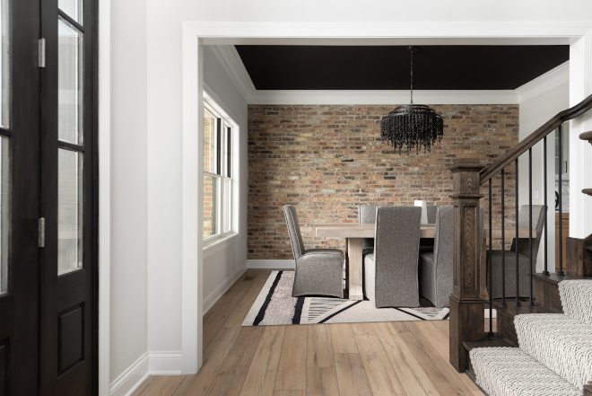 Across the Foyer you will find a formal dining room with a spectacular red brick accent wall complemented perfectly by a darkly painted ceiling #DiningRoom #Foyer#Brickaccentwall #brick #accentwall