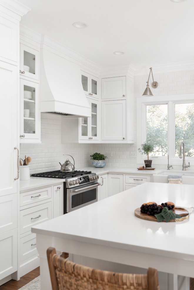 Benjamin Moore Chantilly lace This kitchen pairs a classic and often recommended white paint color on the cabinets white tiles and white countertops that work perfectly with the cabinet color Benjamin Moore Chantilly lace This kitchen pairs a classic and often recommended white paint color on the cabinets white tiles and white countertops that work perfectly with the cabinet color #BenjaminMooreChantillylace #kitchen #classicwhite #recommendedwhitepaintcolor #whitepaintcolor #whitecabinet #whitetile #whitecountertop #cabinetcolor #BenjaminMoore