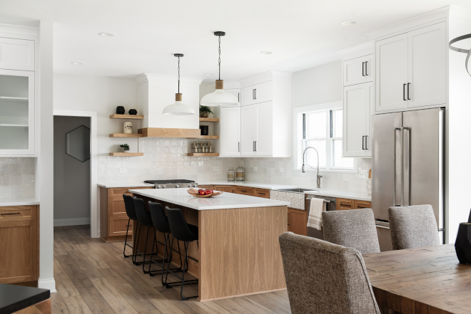 Kitchen with two-tone white and natural finished upper and lower cabinets that have a charming Scandinavian feel in its design #Kitchen #twotonekitchen #whiteandnaturalfinishedcabinet #upperkitchencabinet #whiteoaklowercabinet #Scandinaviankitchen #Scandinavianfarmhouse