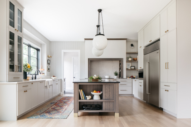 Light Grey Kitchen Featuring warm light grey cabinets and a grey stained island with brass accents this Kitchen is sure to impress with its authenticity #LightGreyKitchen #GreyKitchen #warmgrey #greycabinets #greystainedkitchenisland #brass #Kitchen #kitchedesign