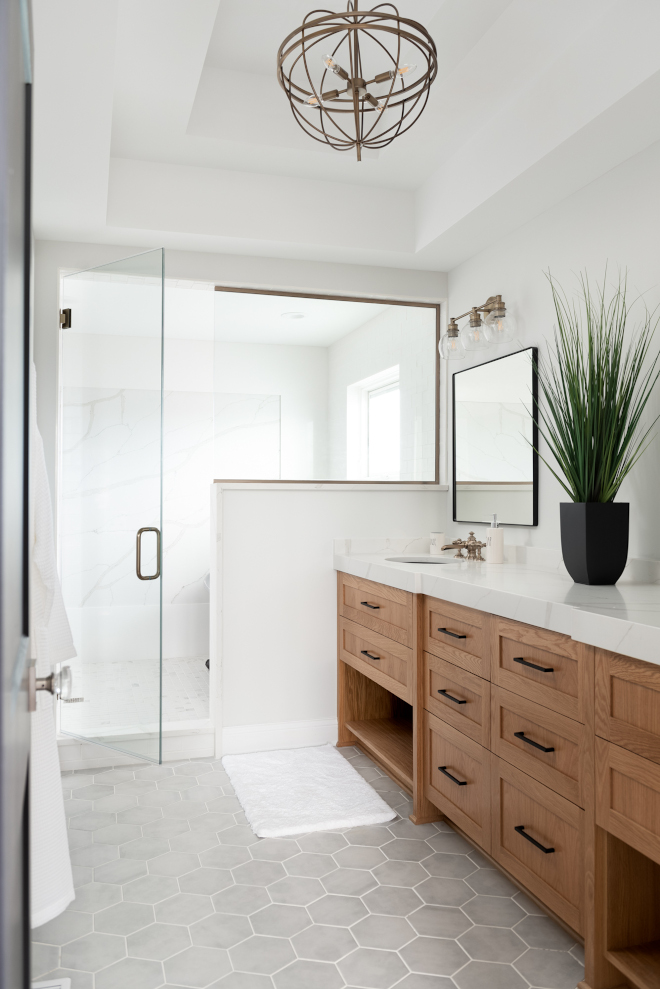 The master bath features his and hers sinks and a wet room with a large soaking tub #masterbath #hisandherssinks #wetroom #soakingtub