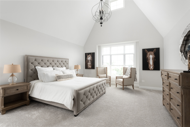 The spectacular master bedroom features a vaulted ceiling, a gorgeous chandelier and is surrounded by massive single hung windows for plenty of natural light #bedroom