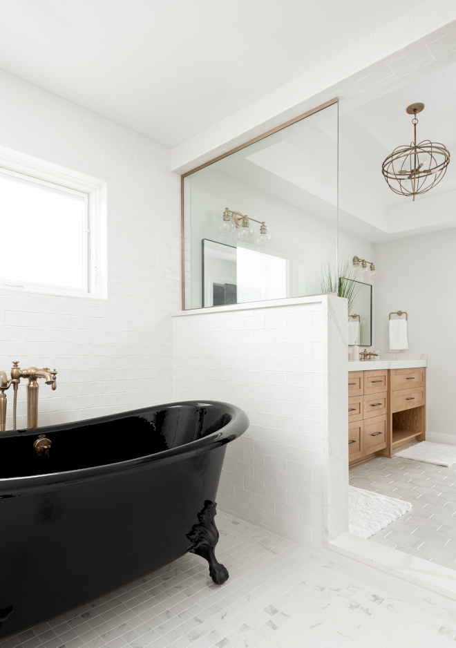 This spa-inspired master bathroom features a wet room and black soaking tub